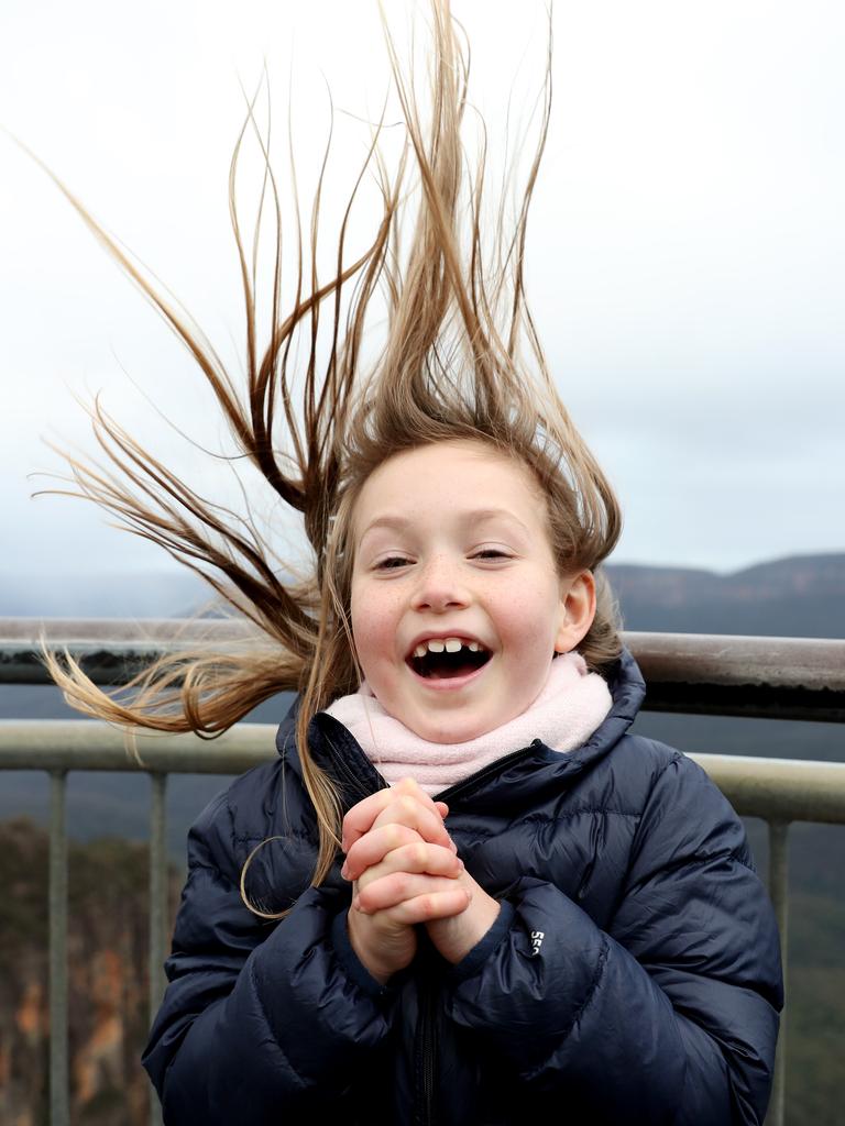 Maisie Nolan, 6, from Bondi at the Echo Point lookout in Katoomba on a cold and windy winters day. The temperature in Katoomba only reached a maximum of 6°C today but with wind gusts of up to 50 km/h it felt much colder! Picture: Jonathan Ng