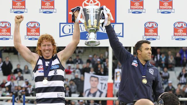 Cameron Ling and Chris Scott lift the premiership cup in 2011.