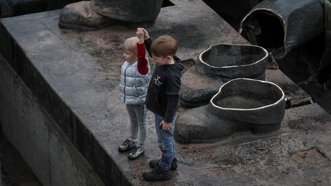 Children on Tuesday stage a mock recreation of Kyiv’s Friendship of Peoples monument, depicting a Ukrainian and Russian worker holding aloft together a Soviet order of friendship, after the 8m statue’s demolition on the orders of the capital’s mayor, Vitali Klitschko. Picture: Reuters