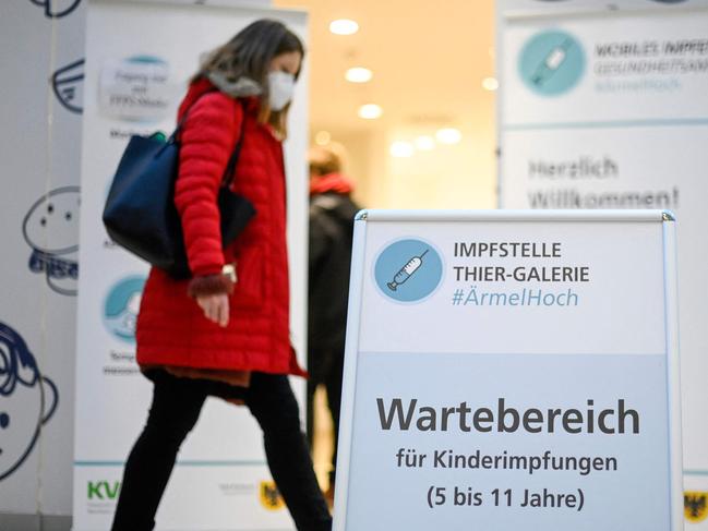 A woman walks past the entrance of a children vaccination centre as a sign reads "Waiting area for vaccination of children between 5 and 12 years old" in Dortmund. Picture: AFP