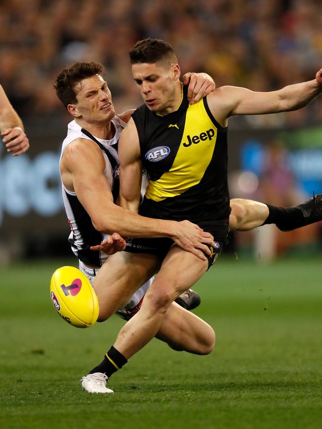 Dion Prestia of the Tigers is tackled by Collingwood’s Brody Mihocek as he prepares to kick. Picture: Michael Willson/AFL Media/Getty Images