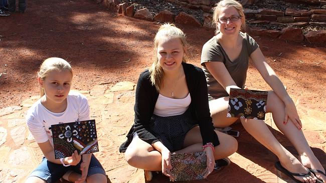 Ella Lassig, Meghan Lassig and Donna Kramer holding their dot paintings. Picture: Supplied 