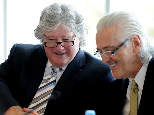 Chairman John Kirby (left) shakes hands with managing director Graham Burke after a Village Roadshow AGM at SeaWorld on Gold Coast. 