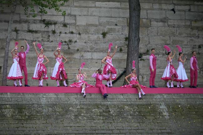 PARIS, FRANCE - JULY 26: Dancers performing French Cancan choreography as part of one of twelve artistic tableaux, are pictured from the boat of Brazil's delegation sailing along the river Seine during the opening ceremony of the Olympic Games Paris 2024 on July 26, 2024 in Paris, France. (Photo by Carl de Souza-Pool/Getty Images)