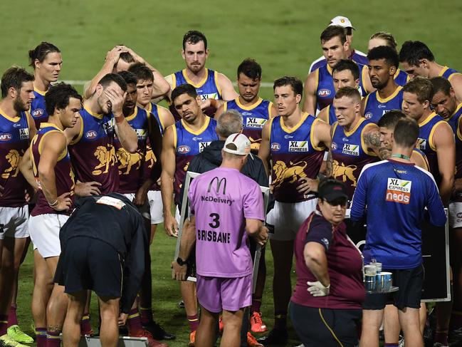 Lions coach Chris Fagan speaks to his players during the contest with the Sydney Swans.