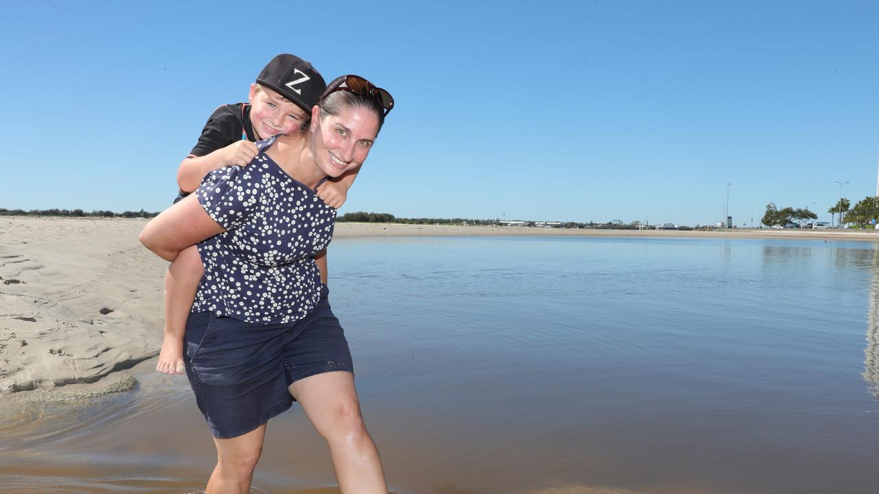 Melissa Clarke gives a piggyback across the water to Zavier Kirkwood 4 from Mt Tamborine.. Picture Glenn Hampson