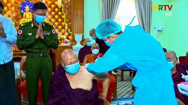 A Buddhist monk being inoculated with a Covid-19 coronavirus vaccine, in Myanmar. Picture: AFP