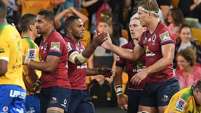 Queensland Reds players celebrate their win over the Bulls.