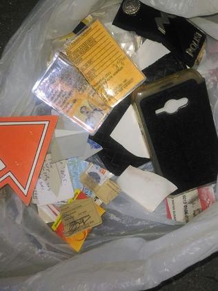 Murdered police officer Wayan Sudarsa's ID cards, wallet, tax card, driver’s licence, gun card, police rank insignia and other belongings were found by a local. Picture: Supplied.