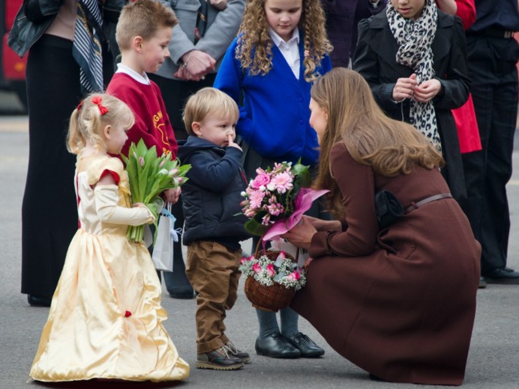 One for the album ... a little boy picks his nose as he talks to Catherine, Duchess of Cambridge during her visit to Peaks Lane fire station in Grimsby, northern England. Picture: AFP