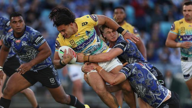 Tino Fa'asuamaleaui of the Titans is tackled during the round 12 NRL match between Canterbury Bulldogs and Gold Coast Titans at Accor Stadium on May 21, 2023 in Sydney, Australia. (Photo by Cameron Spencer/Getty Images)