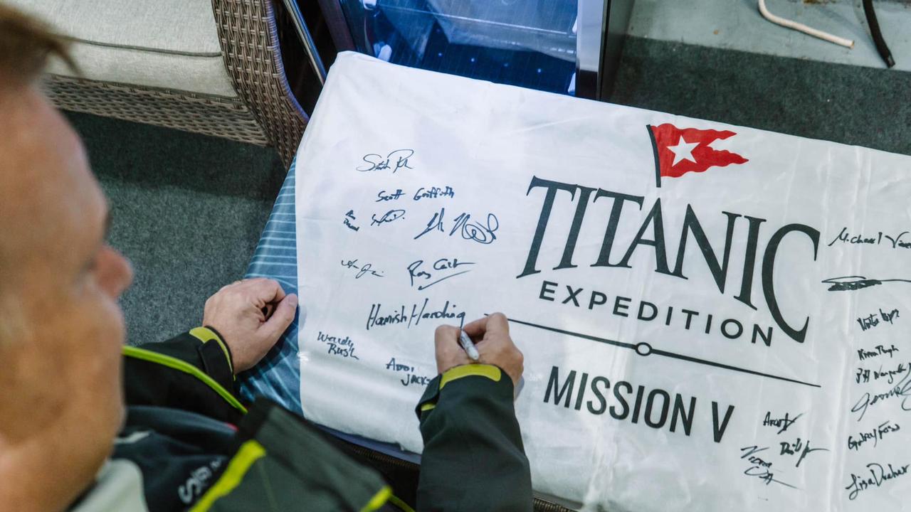 One of the sub victims, Hamish Harding, shared a photo of him signing a flag before the fated expedition. Picture: Facebook/Hamish Harding