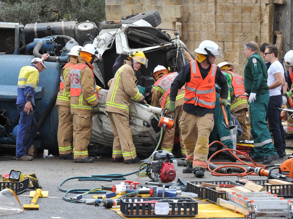 Emergency service workers at the crash on the corner of Glen Osmond and Cross roads. Picture: Roger Wyman