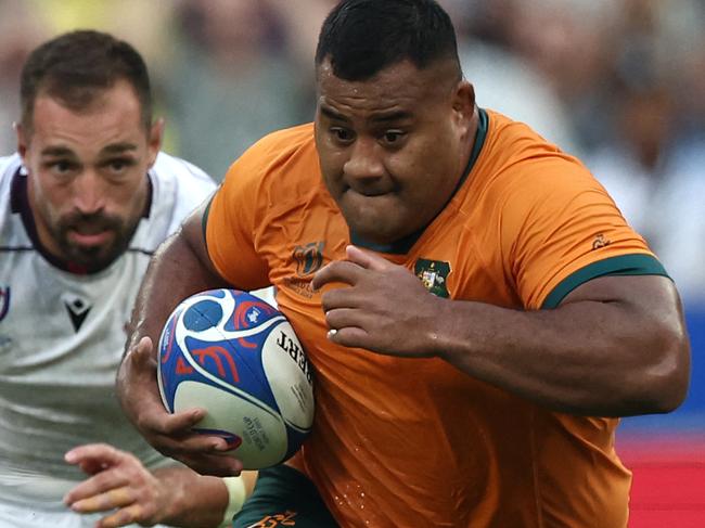 Australia's tighthead prop Taniela Tupou (R) runs with the ball during the France 2023 Rugby World Cup Pool C match between Australia and Georgia at Stade de France in Saint-Denis, on the outskirts of Paris, on September 9, 2023. (Photo by FRANCK FIFE / AFP)