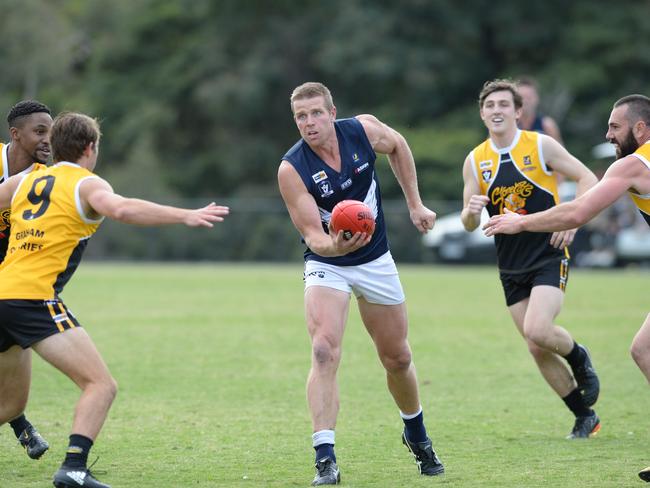 Edi-Asp’s Brett Dore handballs in front of YC’s Michael Debenham (No 9). Picture: Chris Eastman