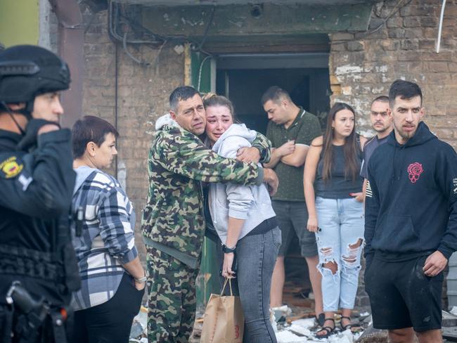 Local residents stand next to a damaged residential building following a missile attack in Zaporizhzhia. At least 13 people were wounded in a series of Russian strikes on Zaporizhzhia in southern Ukraine. Picture: AFP