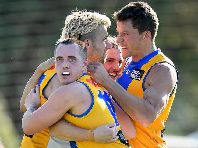 Shane Doherty of Macleod is congratulated by team mates after kicking a goal during the round three NFNL Division 1 Melbourne Greyhounds Seniors match between West Preston-Lakeside and Macleod at JE Moore Park Oval, on April 27, 2024, in Melbourne, Australia. (Photo by Josh Chadwick)