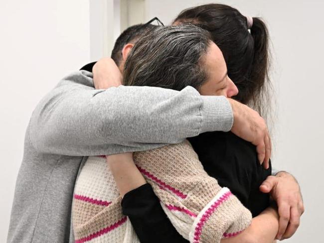 This handout picture released by the Israeli army shows former Israeli hostage Karina Ariev reunited with family at an army screening point in Reim in southern Israel on January 25, 2025. Palestinian militants and Israel carried out a second hostage-prisoner swap on January 25 under the Gaza ceasefire deal, but a last-minute dispute blocked the expected return of hundreds of thousands of Palestinians to devastated northern Gaza. Four freed Israeli women hostages, all soldiers, arrived home in Israel after more than 15 months of captivity in the Palestinian territory. (Photo by Israeli Army / AFP) / === RESTRICTED TO EDITORIAL USE - MANDATORY CREDIT "AFP PHOTO / Handout / Israeli Army' - NO MARKETING NO ADVERTISING CAMPAIGNS - DISTRIBUTED AS A SERVICE TO CLIENTS ==