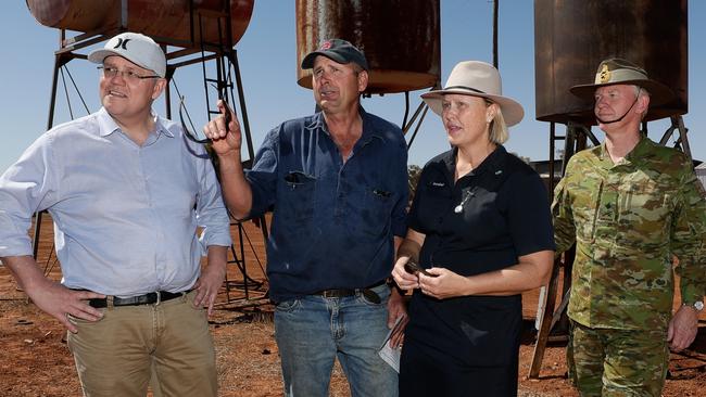 Scott Morrison with graziers Stephen and Annabel Tully and Major-General Stephen Day at Quilpie yesterday. Picture: Alex Ellinghausen