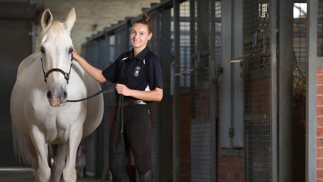 Tiffany Kalderovskis with one police greys at the current site behind the Thebarton Police Barracks. Picture: Dean Martin