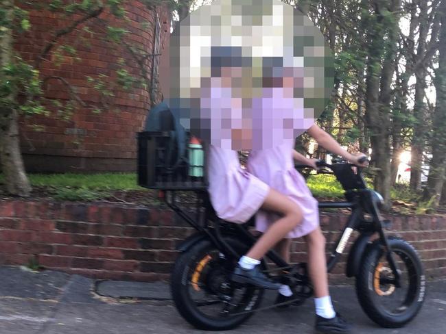 Secondary school students, without helmets, on an e-bike on a footpath at Queenscliff. Picture: Jim O'Rourke