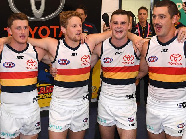 MELBOURNE, AUSTRALIA - APRIL 27:  Matt Crouch, Rory Sloane, Brad Crouch and Taylor Walker of the Crows sing the song in the rooms after winning the round 6 AFL match between St Kilda and Adelaide at Marvel Stadium on April 27, 2019 in Melbourne, Australia. (Photo by Quinn Rooney/Getty Images)