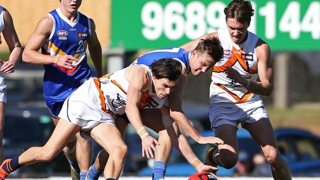 Sam Ramsay and Daniel Mott compete for the ball against Lachlan Stapleton.