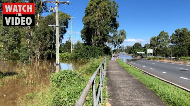 Spectators at Waterford Bridge waiting for the Logan River to peak