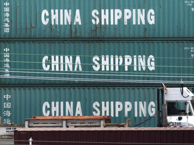 A truck passes by China Shipping containers at the Port of Los Angeles, after new tariffs on Chinese imports was imposed by President Trump, in Long Beach, California on September 1, 2019. - Washington moved ahead Sunday with new tariffs on Chinese imports as it stepped up a high-pressure campaign aimed at coercing Beijing to sign a new trade deal even amid fears of a further slowing of US and world growth. (Photo by Mark RALSTON / AFP)