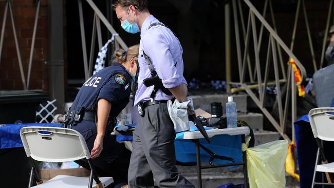 Police looking for evidence in the burnt-out unit after the fatal fire. Picture: Peter Lorimer