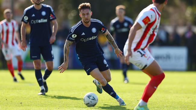 Alex Salmon on the run for Oakleigh Cannons. Picture: Graham Denholm