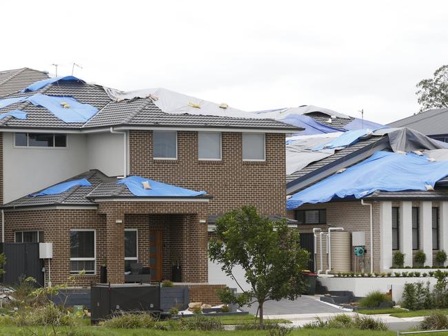 From the roof tops, some of the damaged homes with tarps look like a checkerboard, said Joe Vurchio. Picture: David Swift