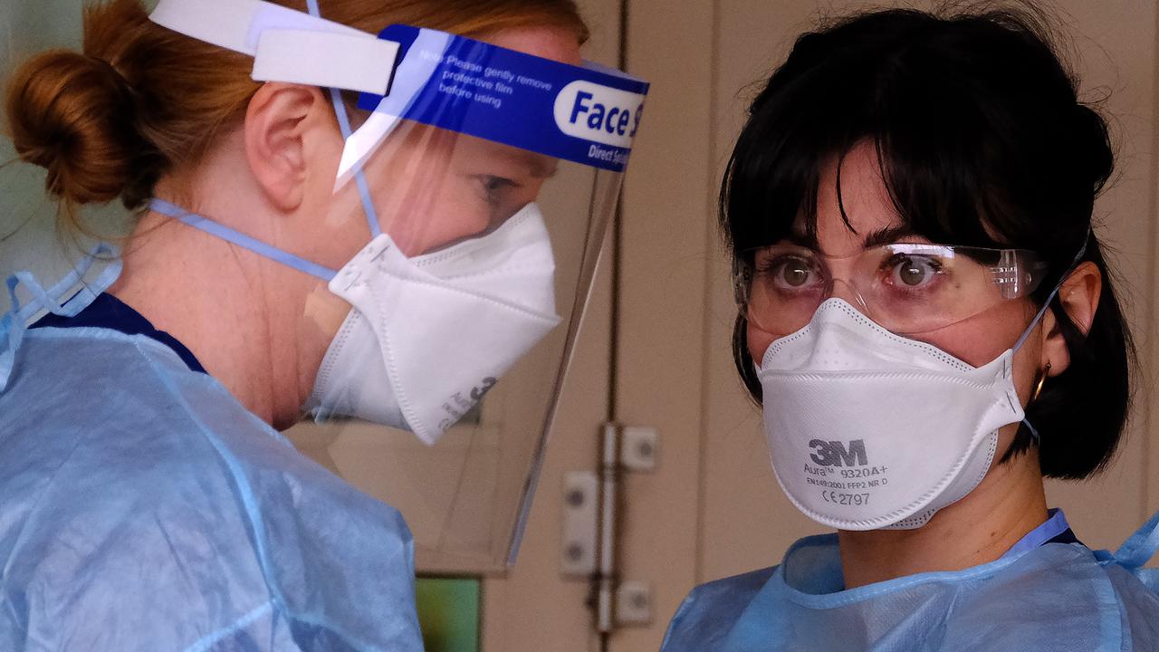 Health workers check on tenants at a locked down Southbank townhouse complex. Picture: NCA NewsWire / Luis Ascui