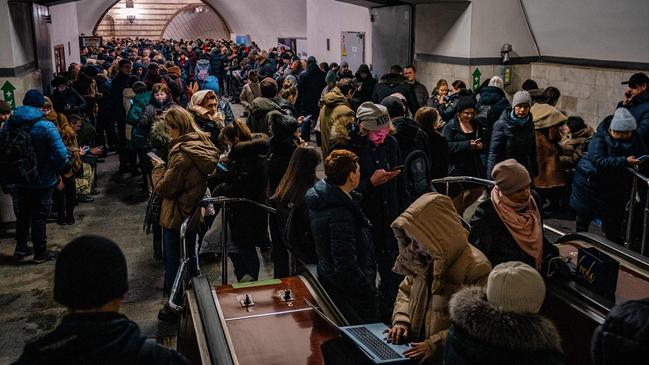 Civilians take shelter inside a metro station during air raid alert in the centre of Kyiv on Friday night. Picture: AFP