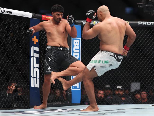 Marcos Rogerio de Lima slams Junior Tafa with a low kick. Picture: Sean M. Haffey/Getty Images