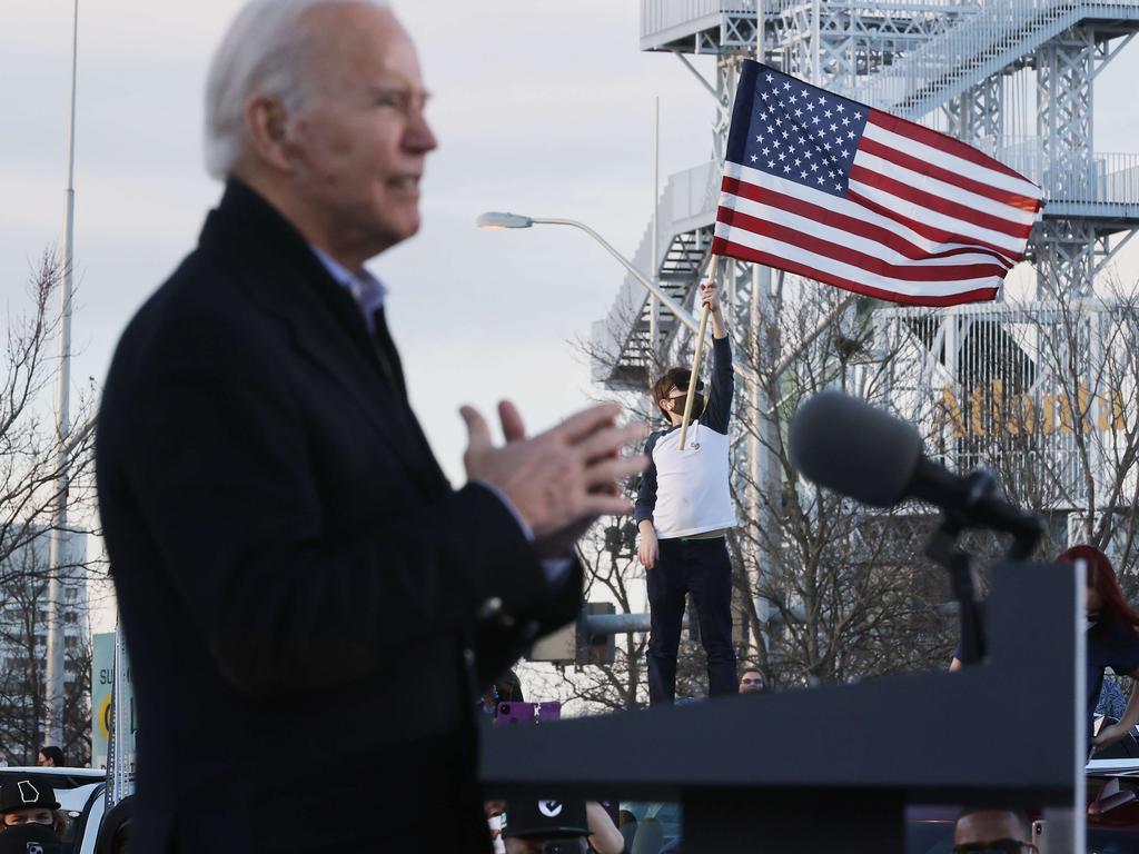 A supporter at Biden’s rally in Georgia holds up the US flag. Picture: Getty Images/AFP