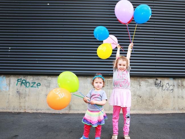 Charlotte, 20 months, and Amelia Reed, 5, pose at Hear &amp; Say in Ashgrove, Brisbane on Wednesday, October 3, 2018. Loud Shirt Day is Friday, October 19. Picture: AAP/Claudia Baxter