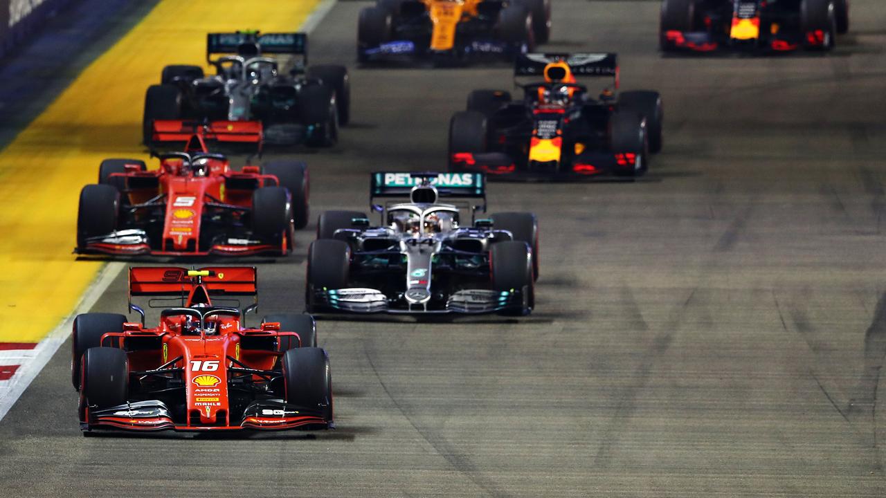 Charles Leclerc leads Lewis Hamilton and the rest of the field at the start in Singapore.