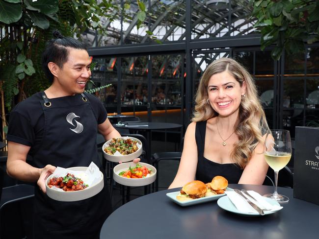 BRISBANE, AUSTRALIA - NewsWire Photos APRIL 26, 2024: Staffer Nara Azis, left, with Tarryn McMullen, owner of the Stratton Bar and Kitchen in Brisbane, promoting the AMEX Delicious Month Out event. Picture: NCA NewsWire/Tertius Pickard