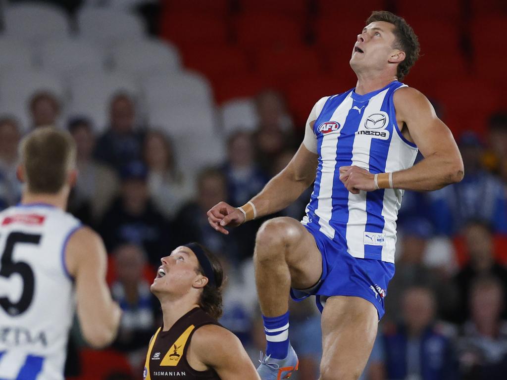 Charlie Comben flies high over Jack Ginnivan. Picture: Michael Klein