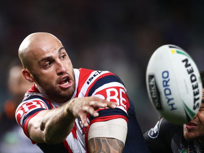 Blake Ferguson of the Roosters offloads the ball in a tackle during the round 13 NRL match between the Sydney Roosters and the Wests Tigers.