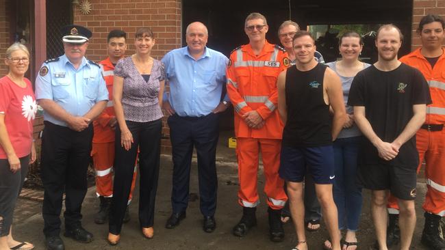 East Hills MP Wendty Lindsay, fourth from left, Emergency Services minister David Elliott, blue shirt, Bankstown SES commander David Niven, centre with police, SES volunteers and locals at Carinya Rd, Picnic Point during the recent flooding.