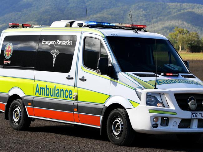 Emergency services attend a fatal car crash on the Bruce Highway, south of Townsville at Mount Surround. Garbage truck driver being looked over by paramedics.  Picture: Alix Sweeney