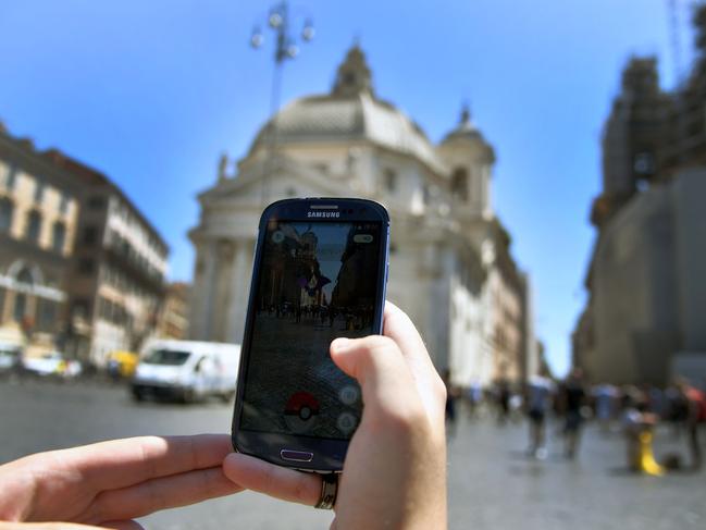 A woman plays Pokemon Go in central Rome, Italy. Picture: AFP