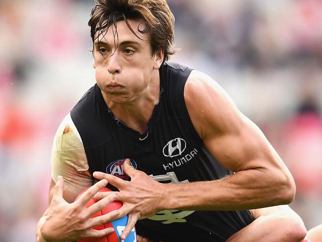 MELBOURNE, AUSTRALIA - APRIL 29:  Caleb Marchbank of the Blues is tackled during the round six AFL match between the Carlton Blues and the Sydney Swans at Melbourne Cricket Ground on April 29, 2017 in Melbourne, Australia.  (Photo by Quinn Rooney/Getty Images)