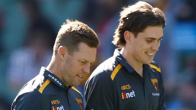 MELBOURNE, AUSTRALIA - MARCH 23: Sam Mitchell, Senior Coach of the Hawks and Will Day of the Hawks look on during the 2024 AFL Round 02 match between the Hawthorn Hawks and the Melbourne Demons at the Melbourne Cricket Ground on March 23, 2024 in Melbourne, Australia. (Photo by Michael Willson/AFL Photos via Getty Images)