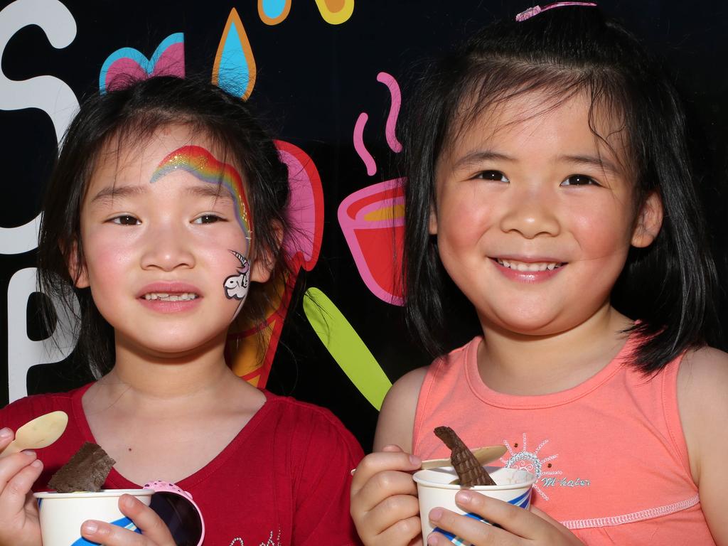 Friends Cherie, 6, and Caroline, 6, kept cool with ice creams at the Santos TDU, Stage 4 Adelaide Street Circuit, on Sunday, January 13. Picture: AAP/Emma Brasier