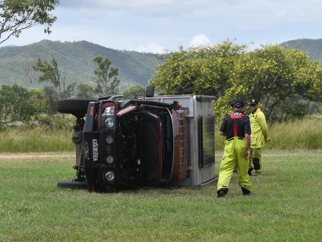 Firefighters attend a single-vehicle rollover on Wharf St at Depot Hill.