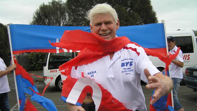 Didn't spill a drop: Kicka O'Rourke bursts through the banner on his 50th footy trip in 2014.