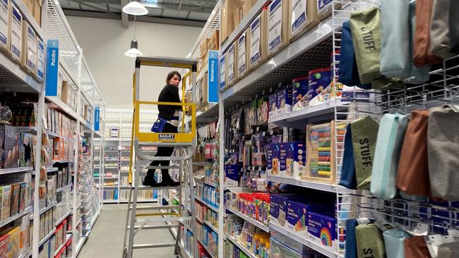 Officeworks Lismore staff placing the final touches as the newly rebuilt store reopens after catastrophic floods in February.